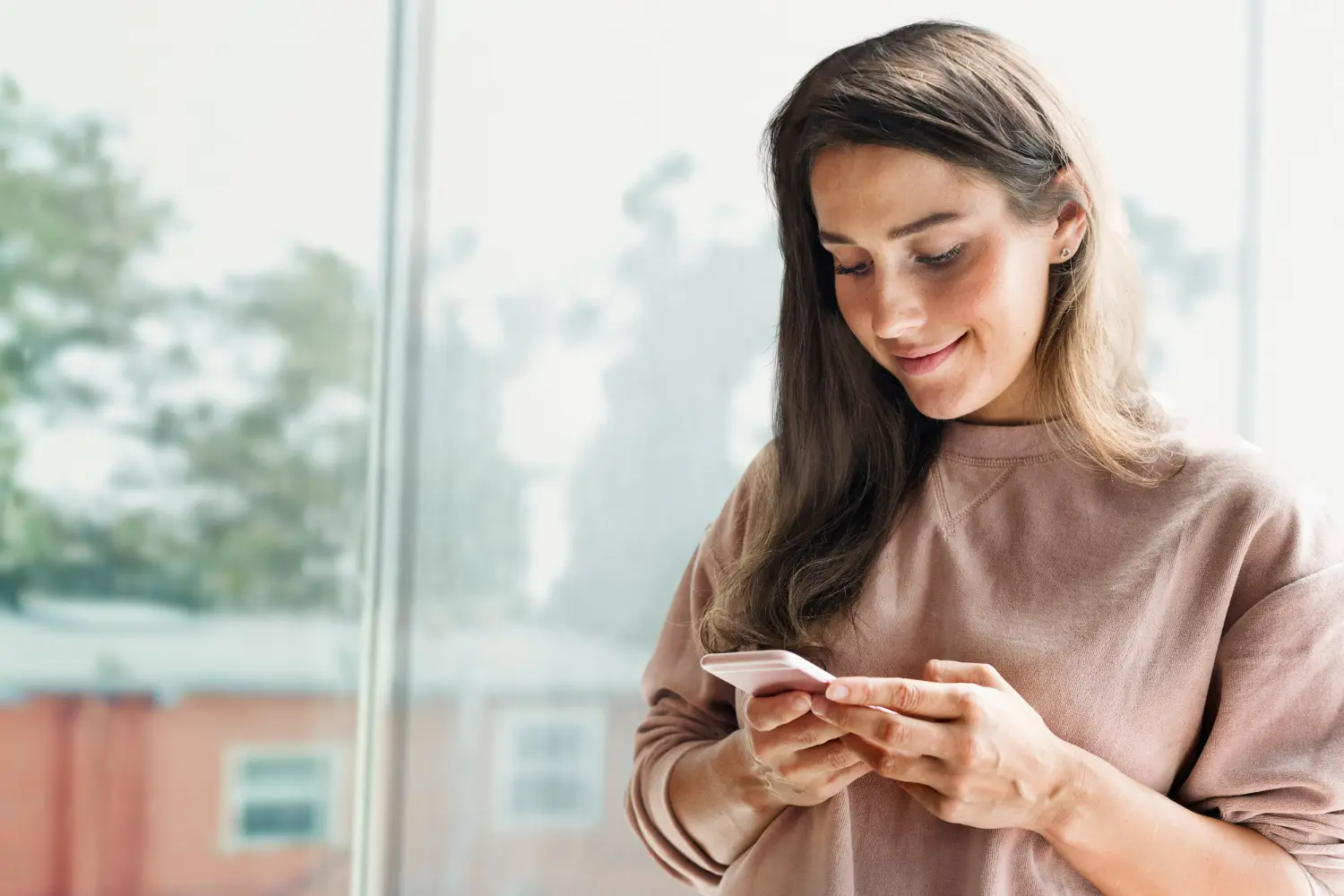 Woman checking updates and messages on an alumni engagement app on her mobile device