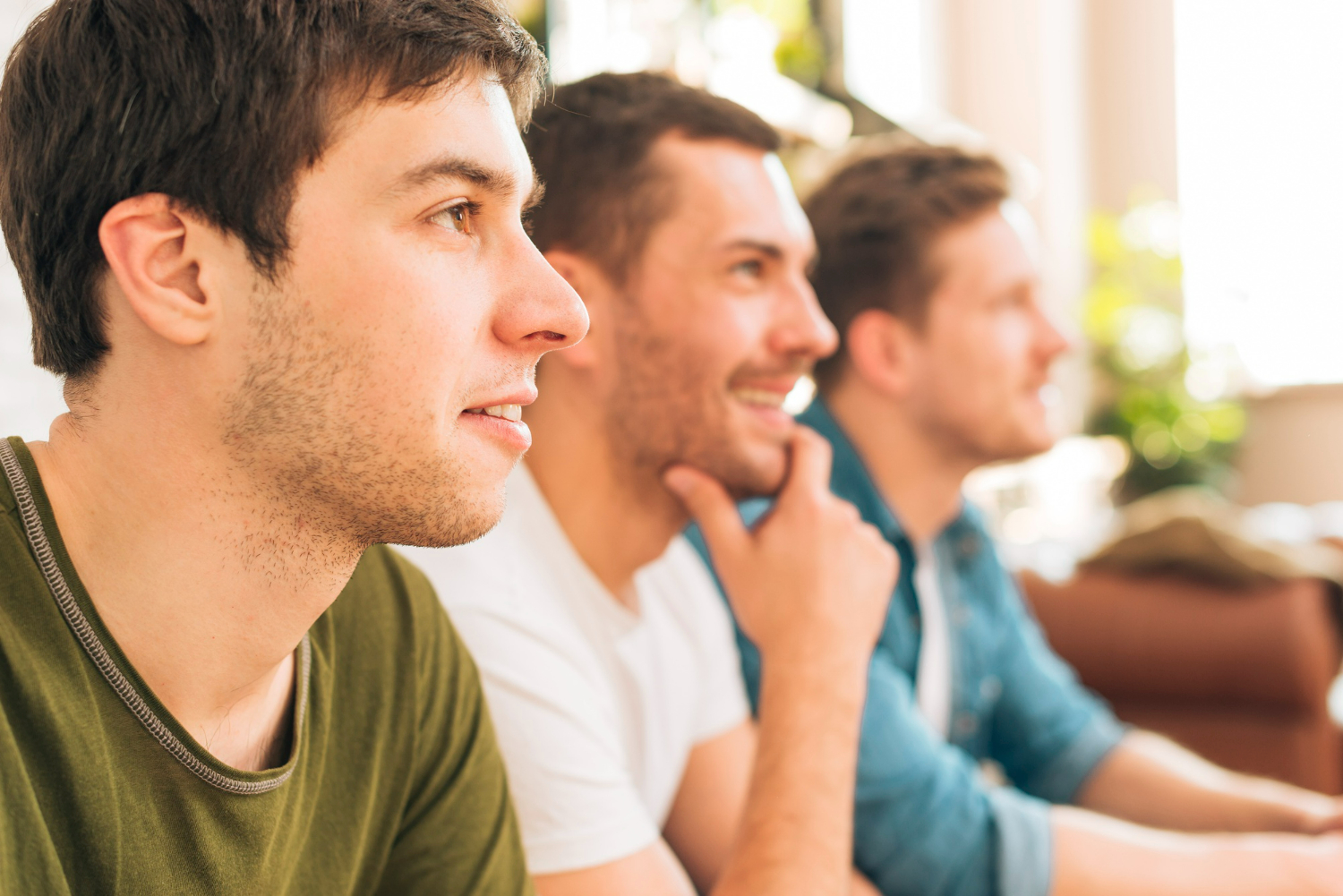 Group of men engaged and attentive during a recovery meeting, highlighting the importance of ongoing follow-up and long-term outcome tracking