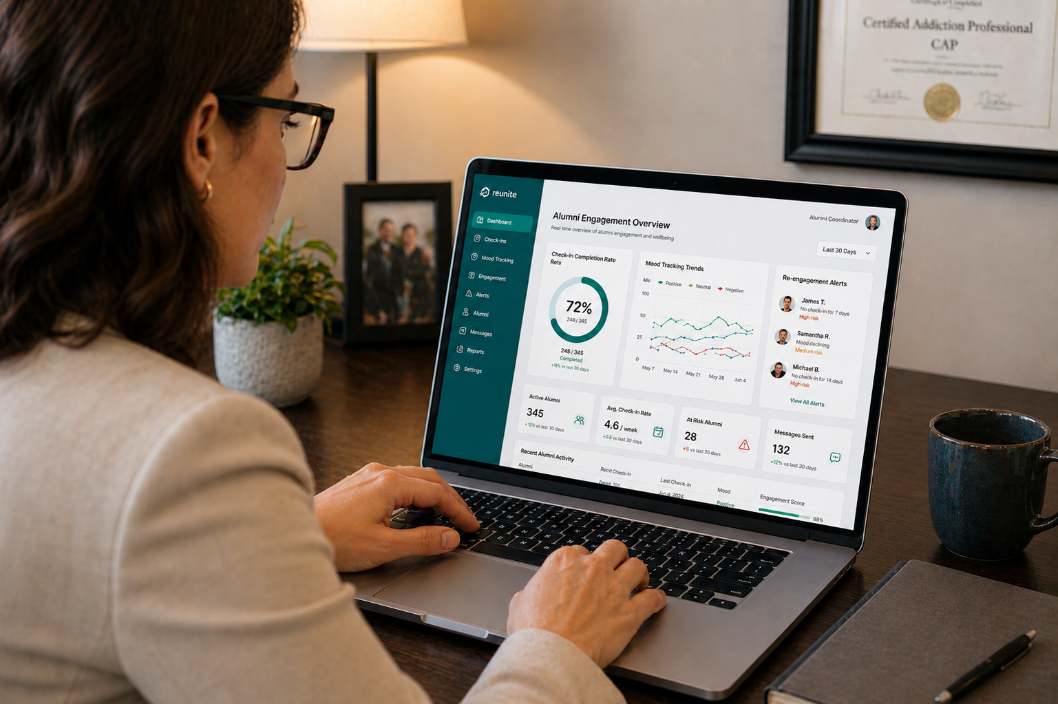 A treatment center alumni coordinator reviewing a dashboard in the best alumni platform for addiction recovery, showing check-in completion rates, mood tracking trends, and re-engagement alerts