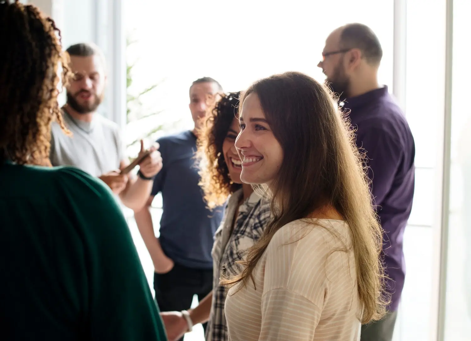 Alumni from an addiction treatment center reconnecting at a recovery community event that supports long-term sobriety and peer relationships
