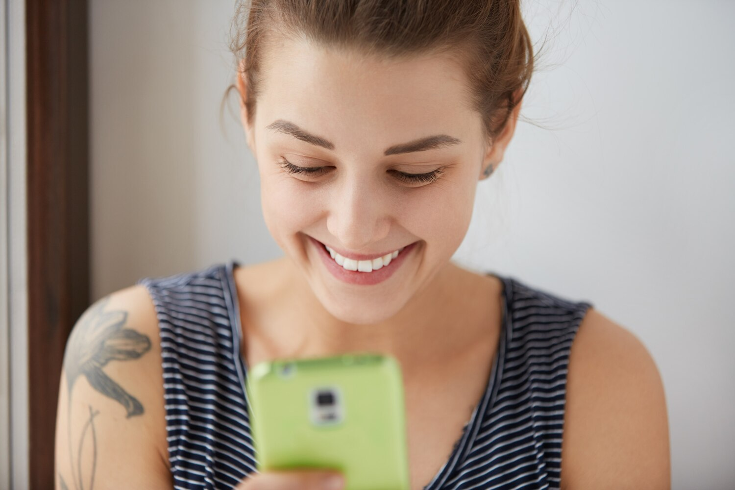 Woman using a mobile behavioral health app to stay connected with her care and recovery