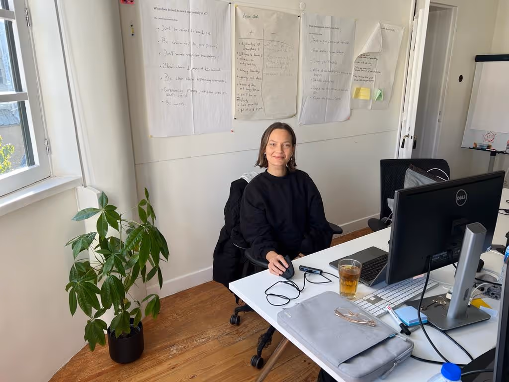 smiling Magda Sokol sitting in the office in front of computer