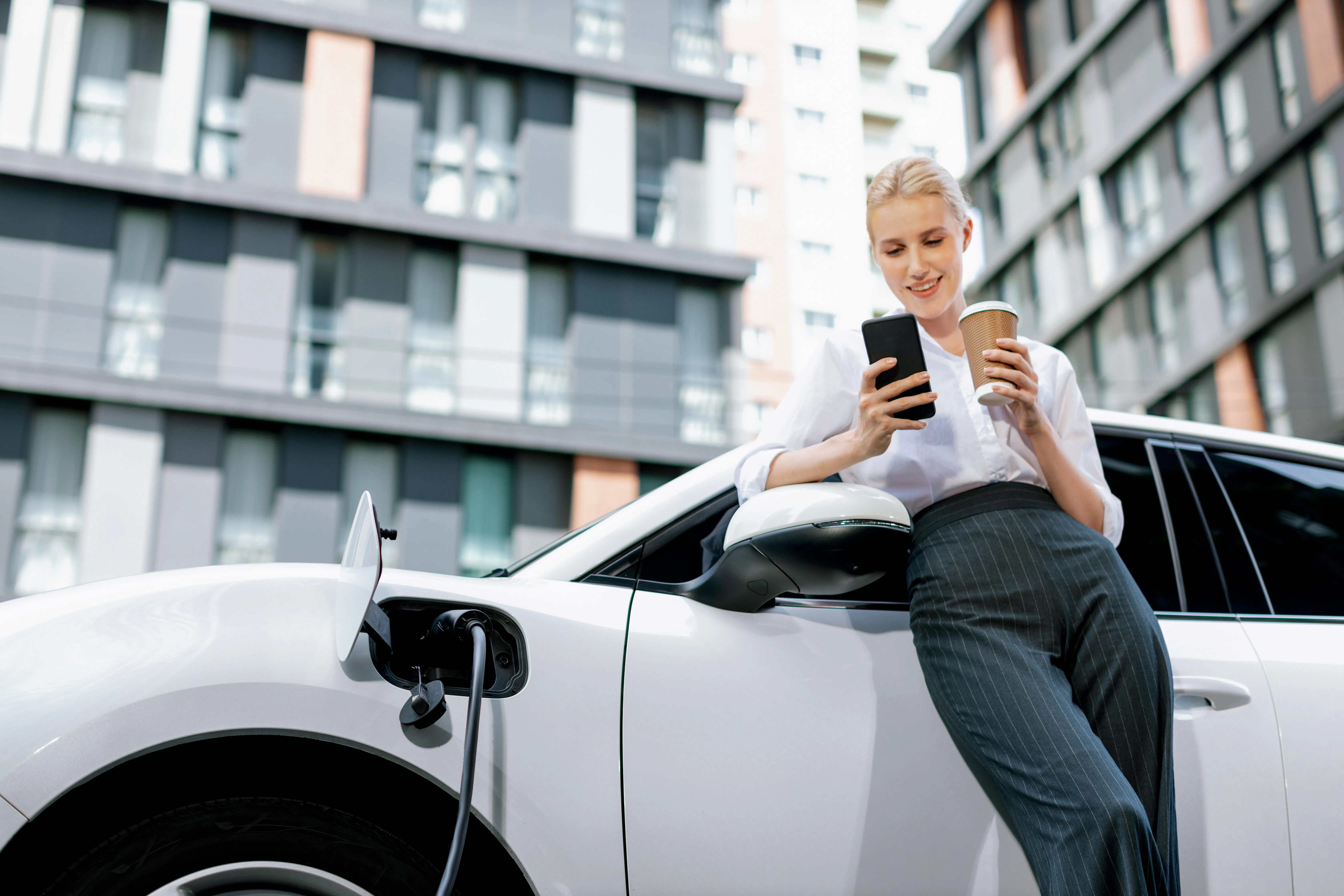Woman easily charging EV in multi-unit dwelling with Ampure Go