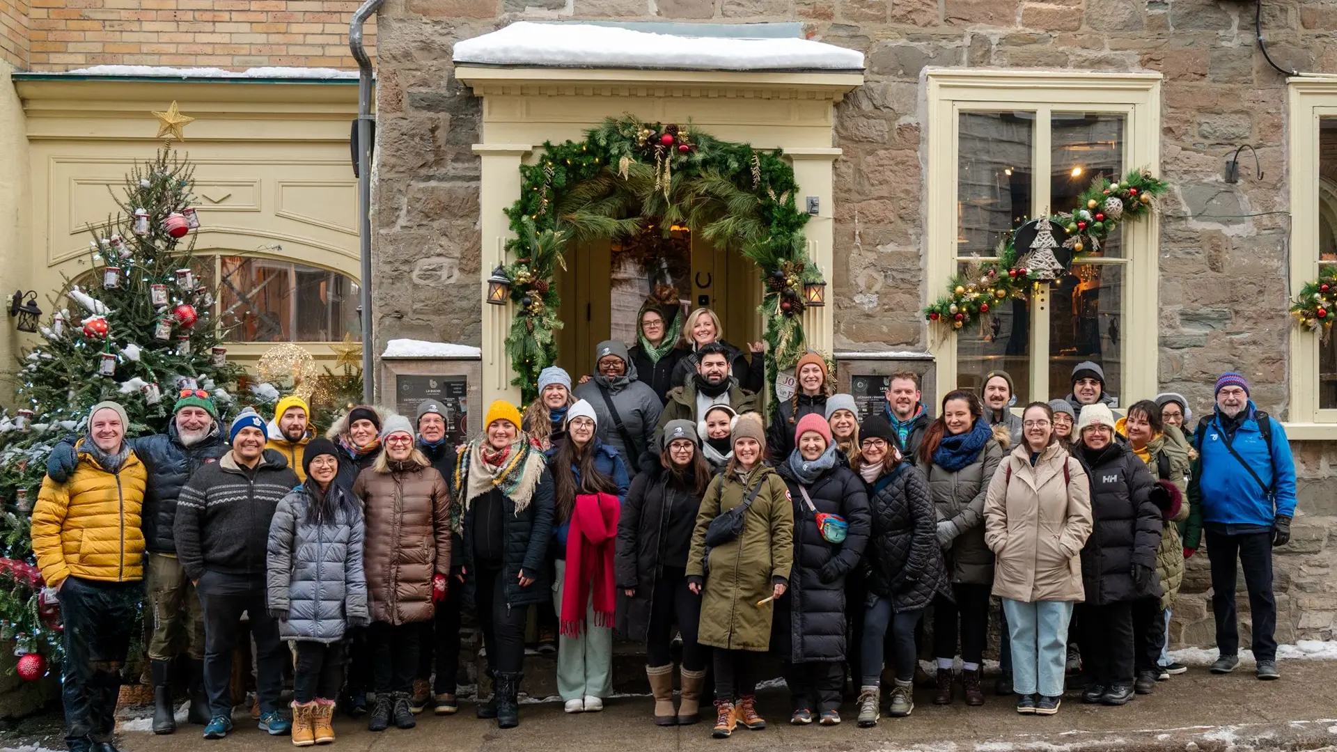 adventure canada office team together in front of a restaurant in quebec