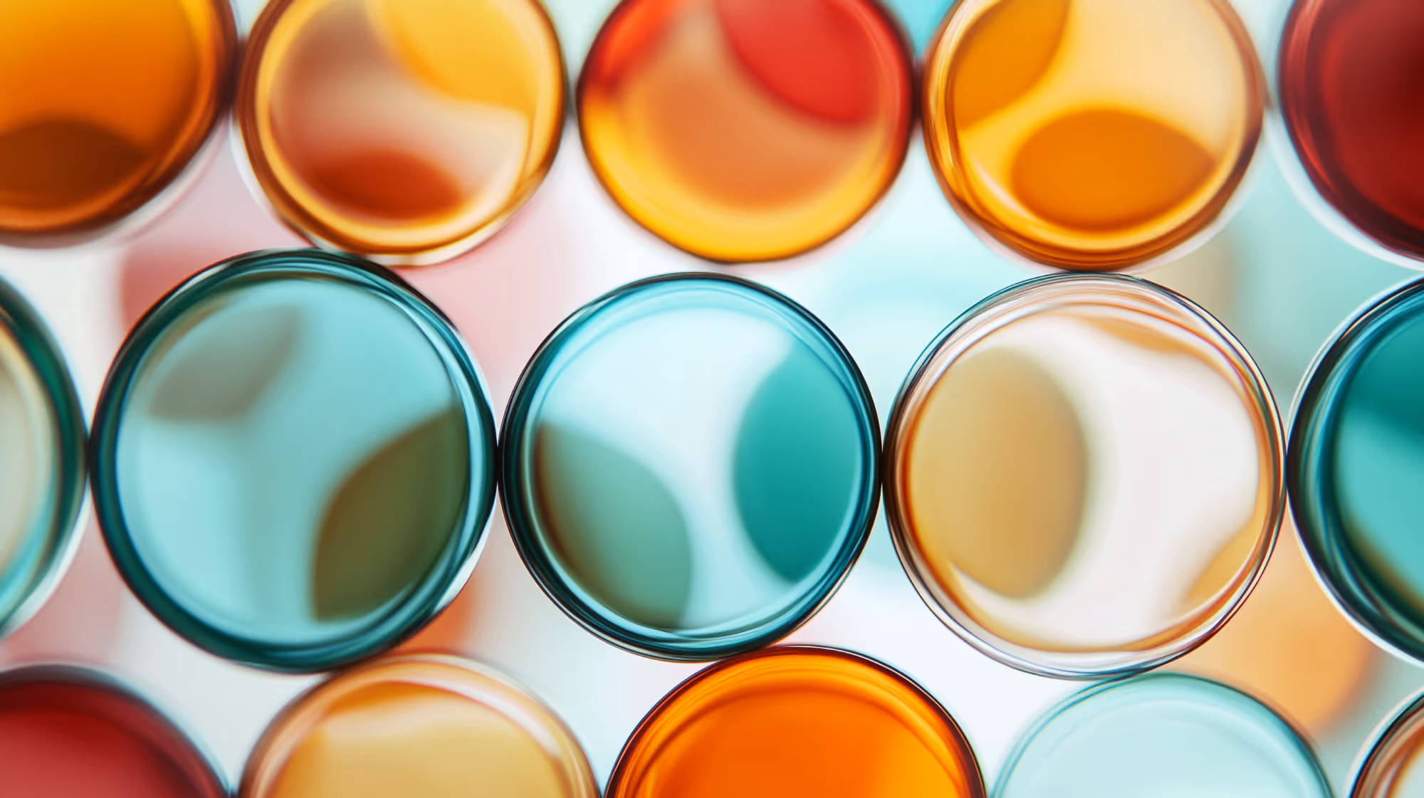 Close-up of colorful translucent glass circles in shades of orange, blue, and red.