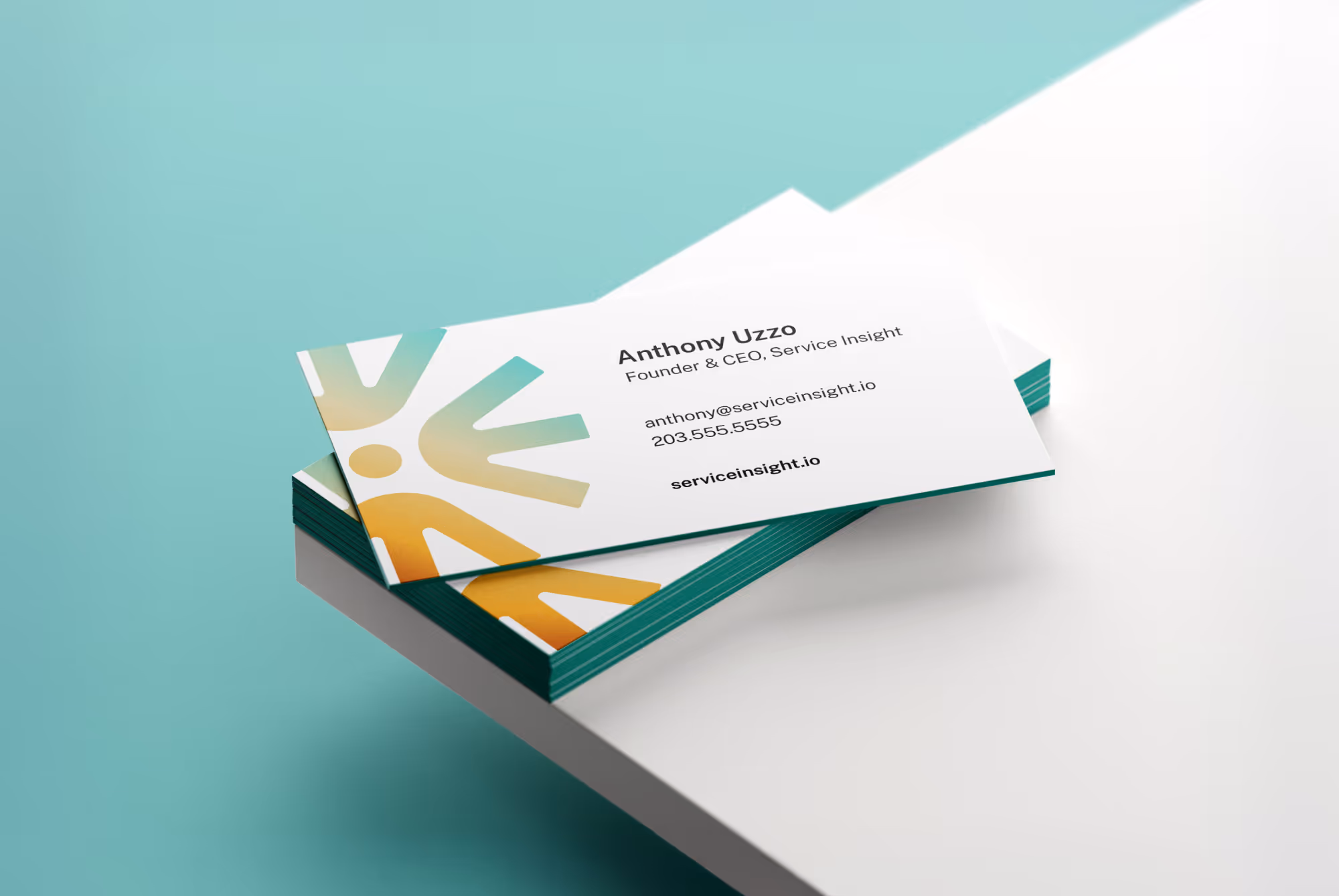 Stack of business cards with a teal and orange abstract logo, showing contact details for Anthony Uzzo, Founder & CEO of Service Insight.