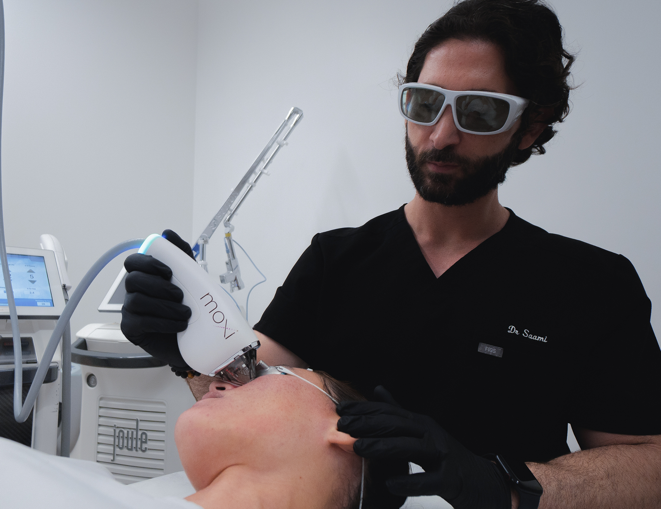 Dr. Saami treating a patients uneven skin texture & pore size with laser skin resurfacing in san diego