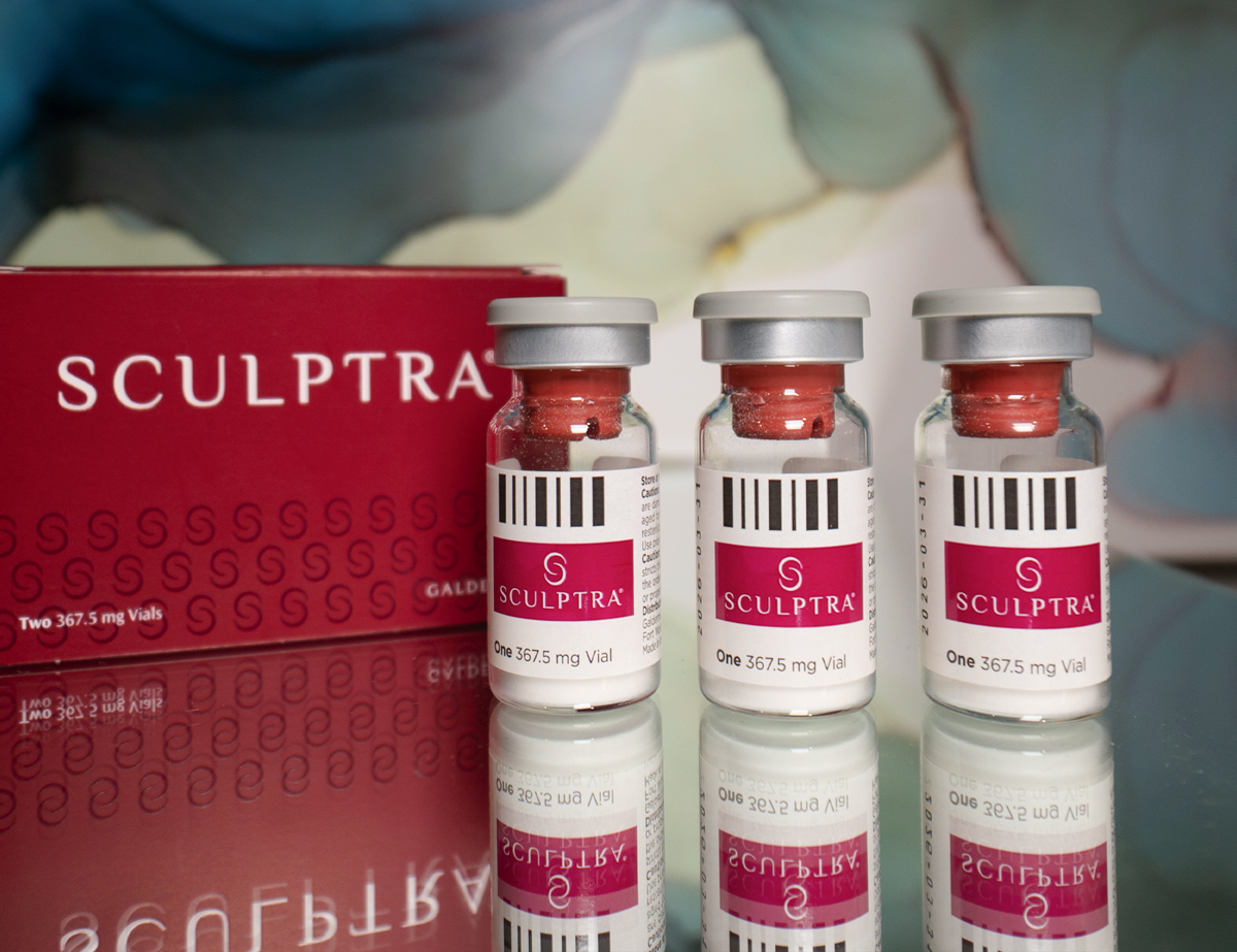 Table with 3 vials of Sculptra on it at SOM Aesthetics in San Diego