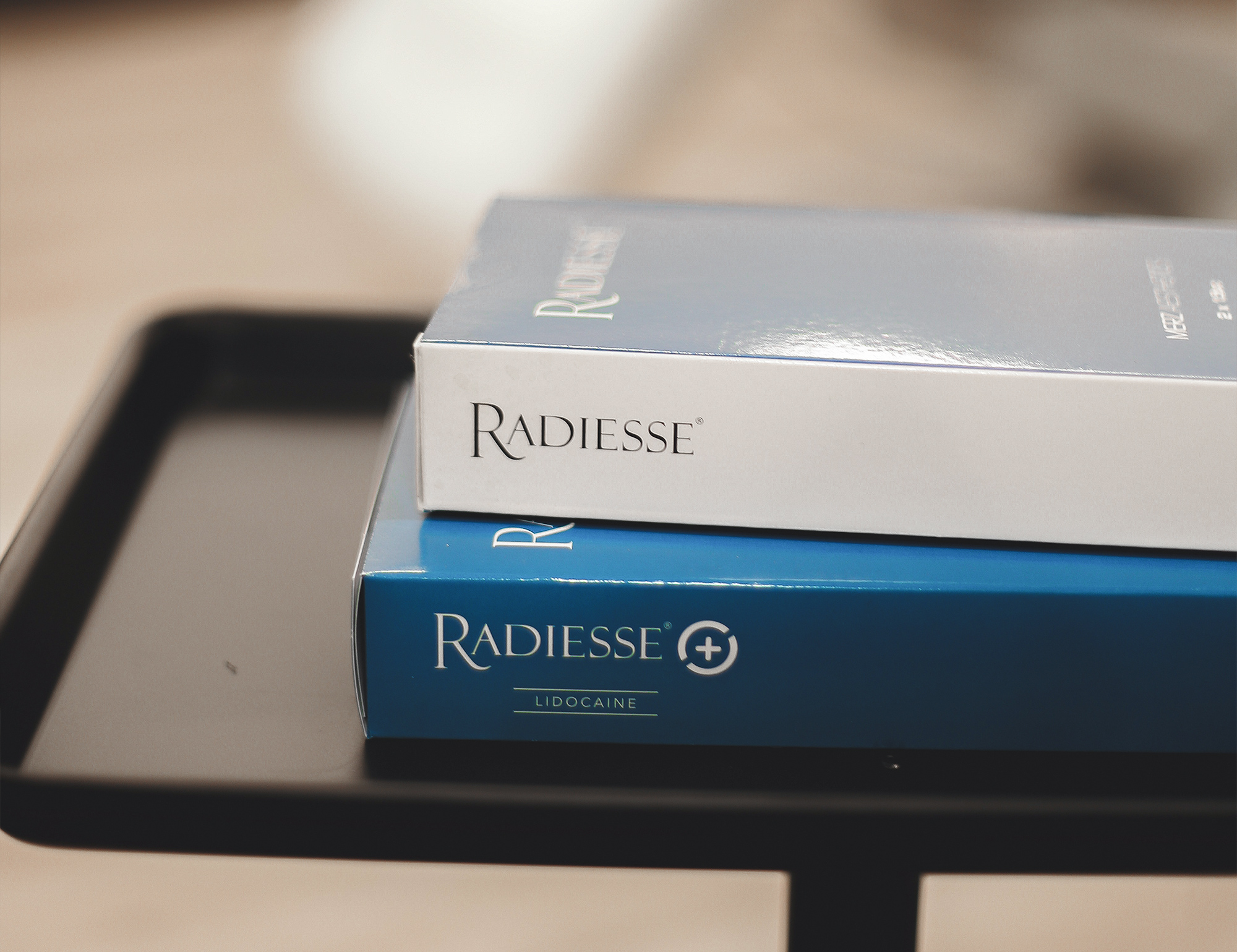 Two boxes of Radiesse on a table at SOM Aesthetics in San Diego