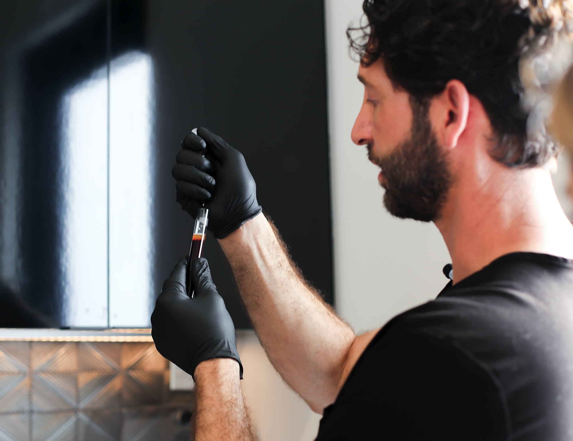 Dr. Saami at SOM Aesthetics in San Diego fills syringe with PRP