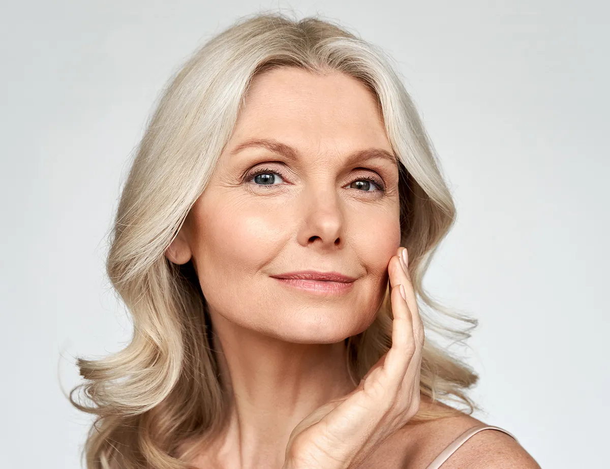 Middle ages woman smiling and showing off results from RF microneedling in San Diego