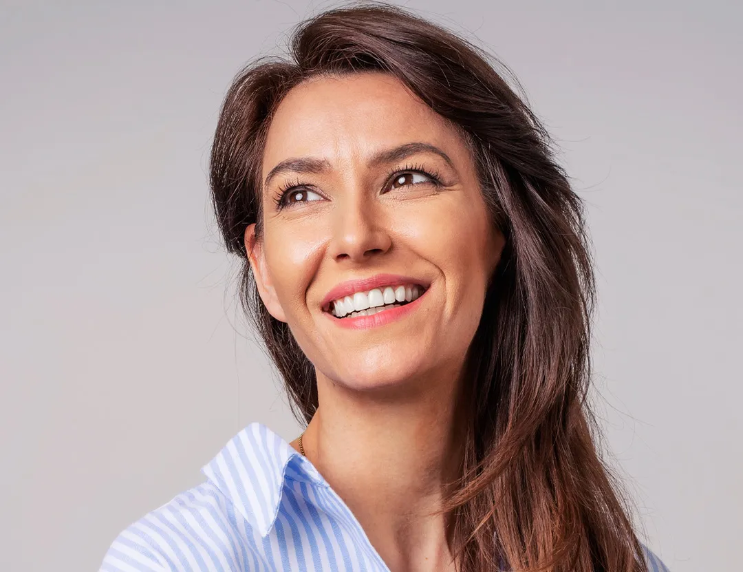 Close up of smiling woman glowing after receiving rf microneedling in San Diego