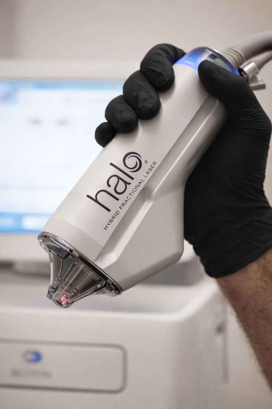 A professional holding the Halo Hybrid Fractional Laser handpiece for advanced skin resurfacing and rejuvenation treatments at SOM Aesthetics in Encinitas