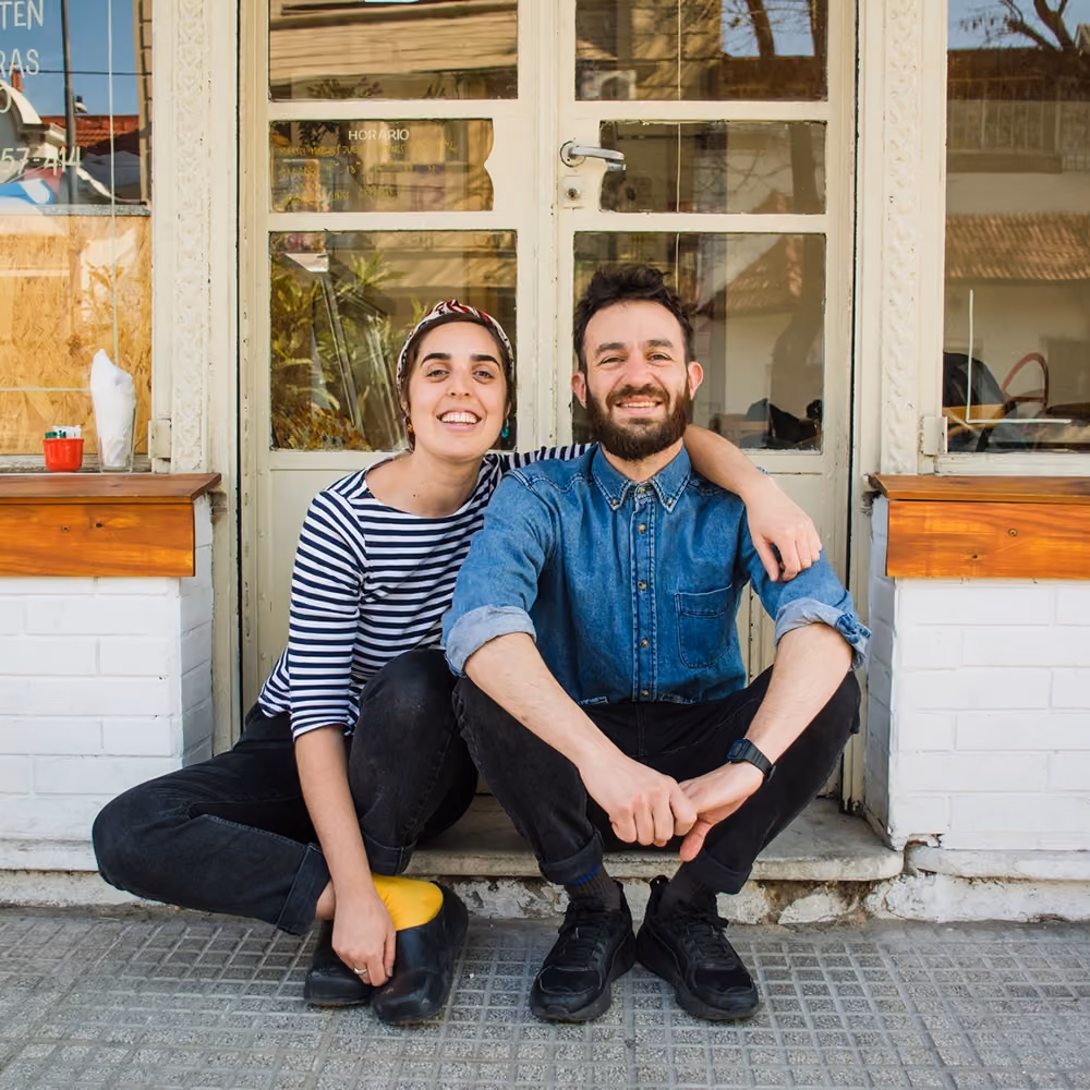 Man and woman in front of their shop
