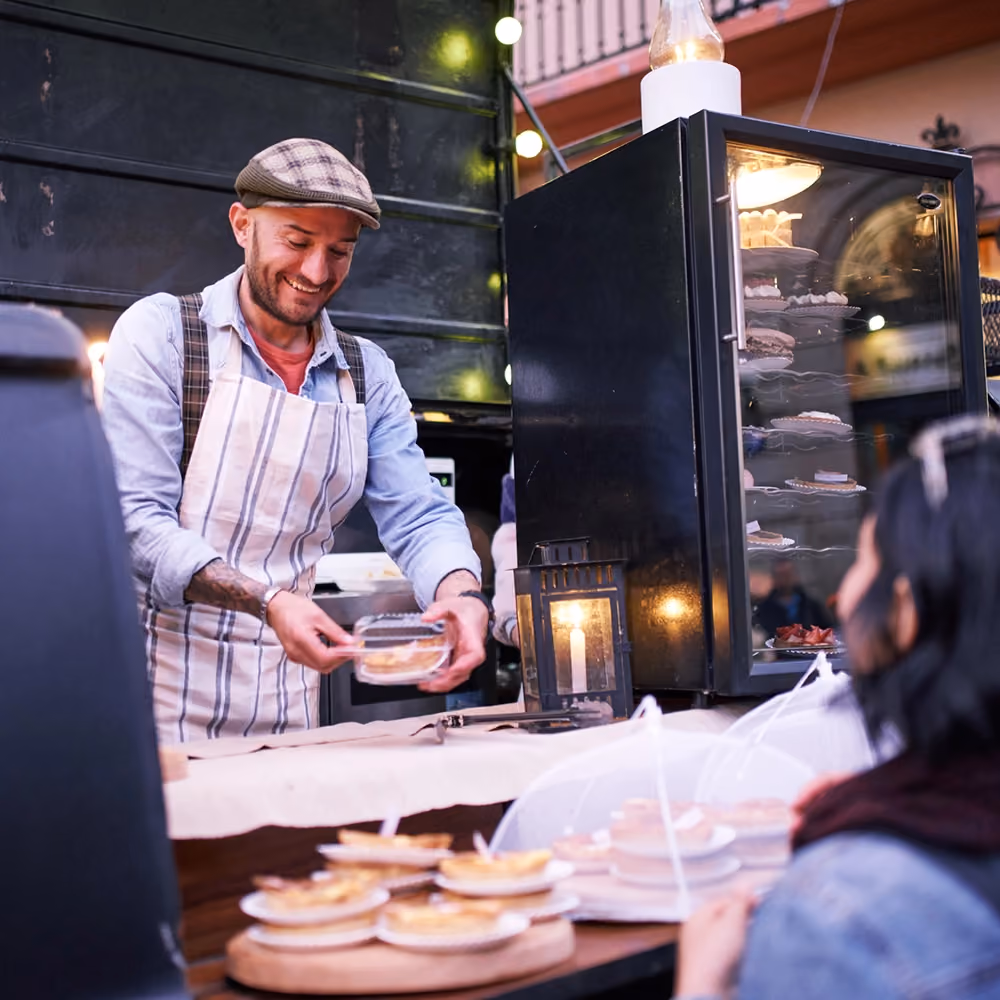 Small business man serving customer