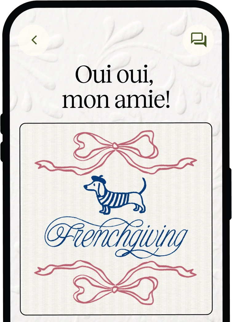 Smartphone screen displaying a message in French 'Oui oui, mon amie!' above an illustration of a small dog dressed in a striped shirt and beret with the word 'Frenchgiving' underneath, framed by pink ribbon bows at top and bottom.
