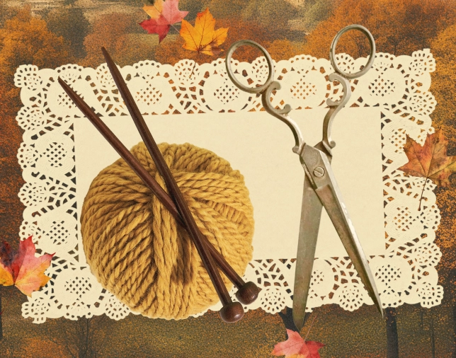 A ball of mustard yellow yarn with two wooden knitting needles resting on it, alongside a pair of vintage metal scissors, placed on a white lace doily with autumn leaves scattered around on a rustic brown surface.