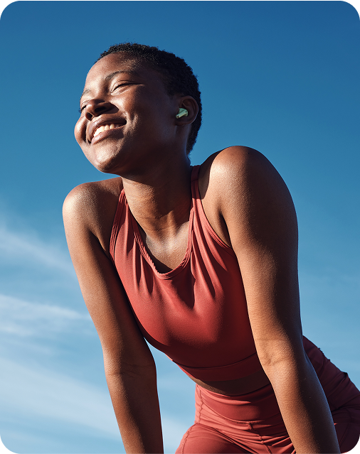Athletic young woman against blue sky