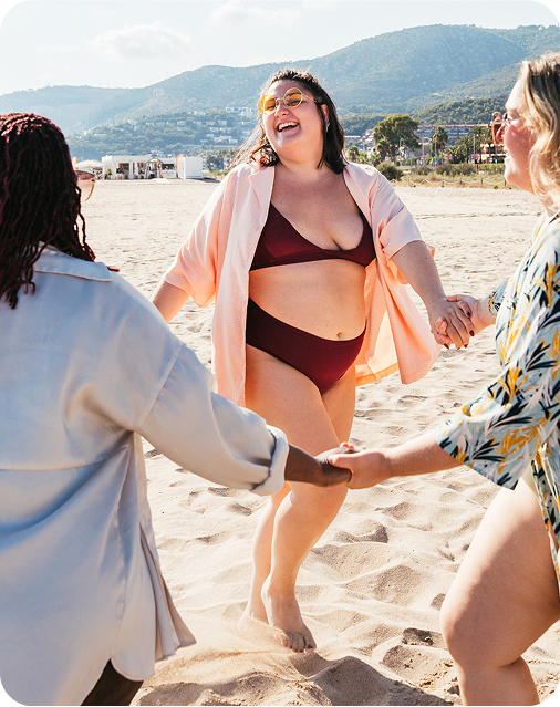 Group of female friends dancing on the beach