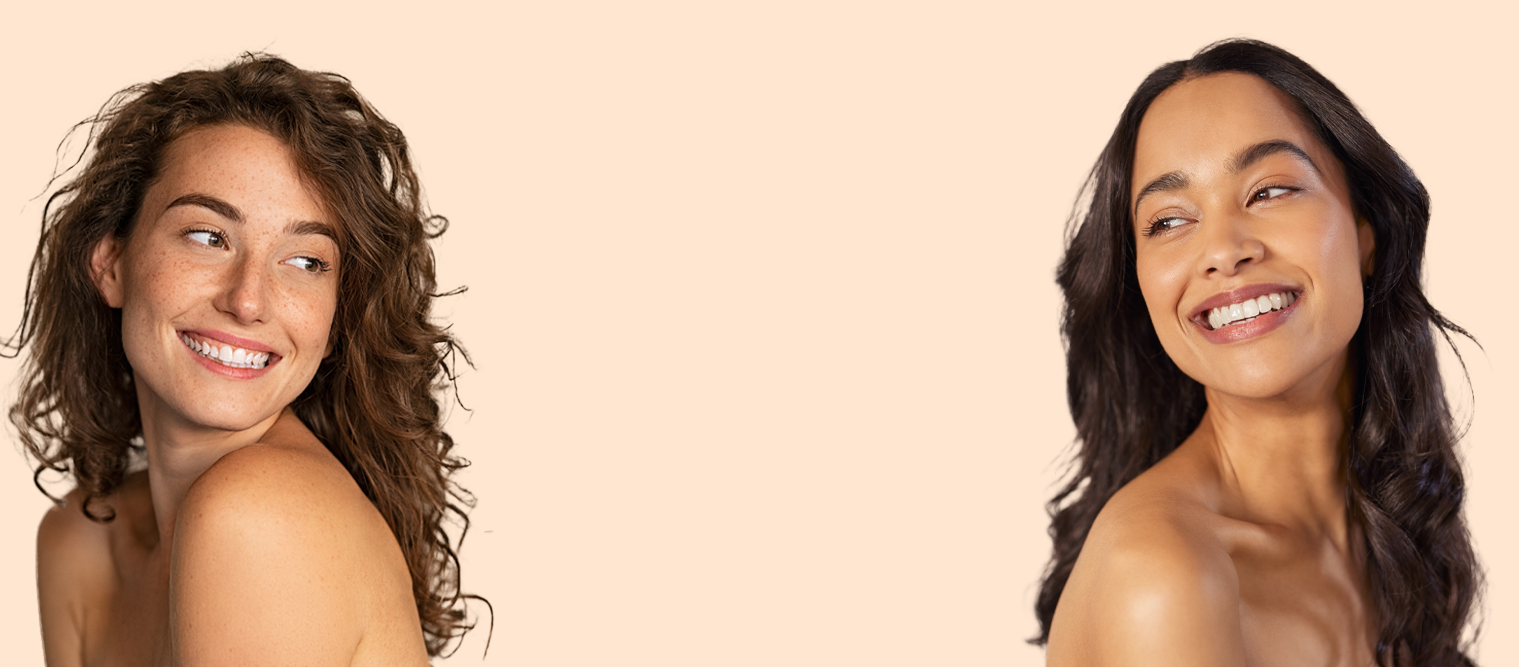 Two young healthy women looking at each other smiling