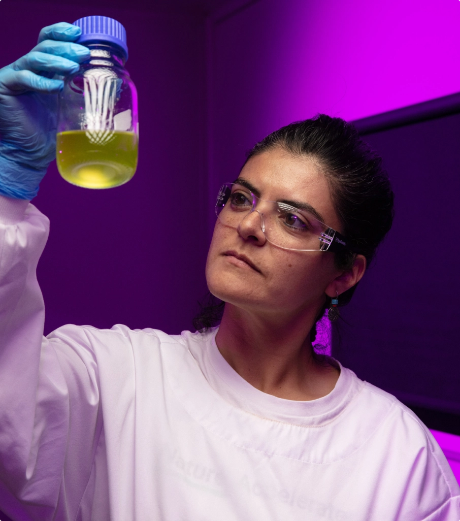 Person in lab with beaker