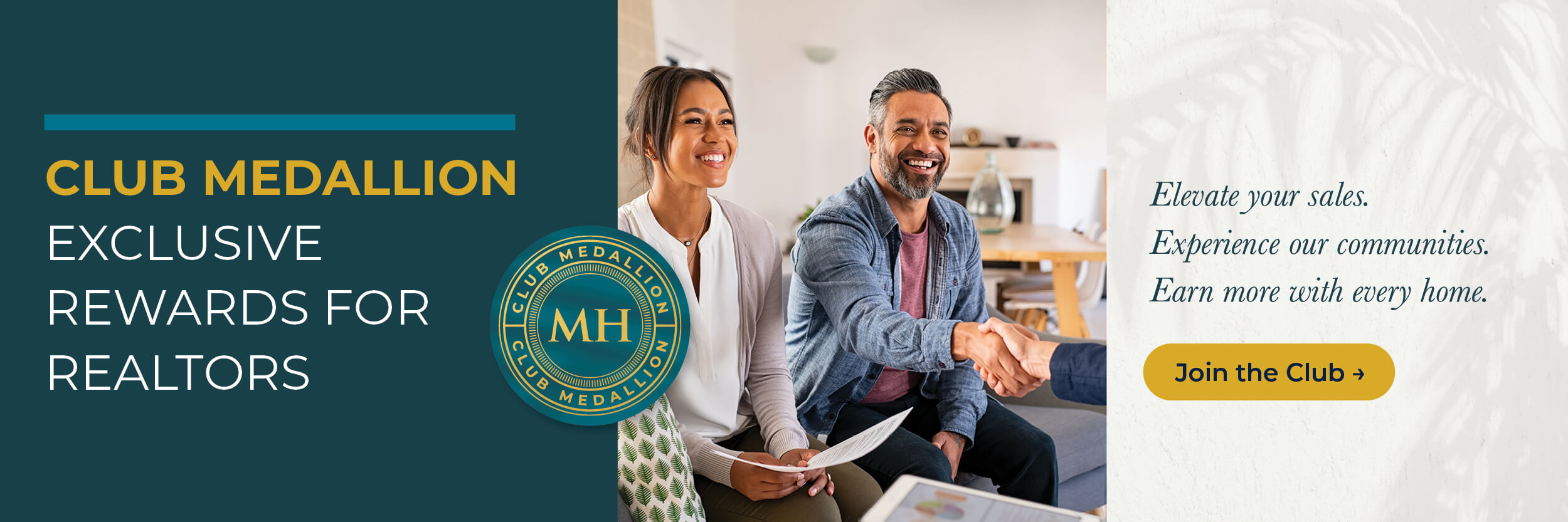 Happy couple smiling while shaking hands with a realtor in a modern home setting.