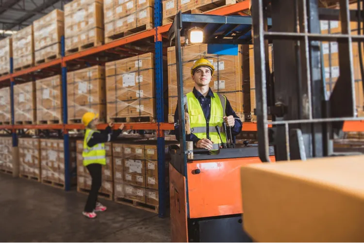 Worker drives a forklift