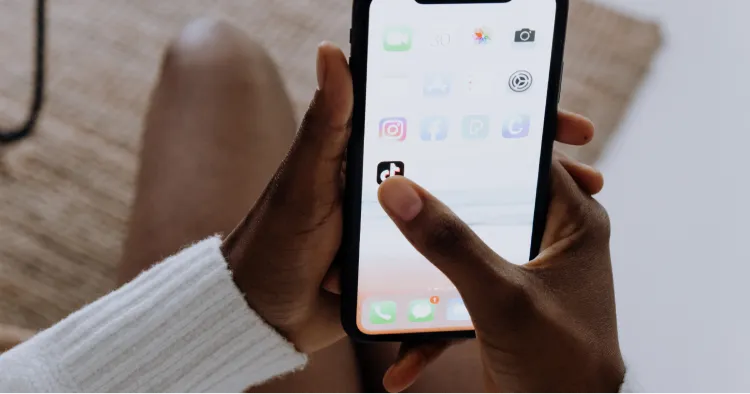 Hand clicking on tiktok icon