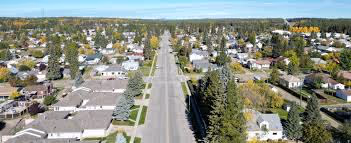 Aerial view of a tree-lined residential street in Whitecourt, Alberta.