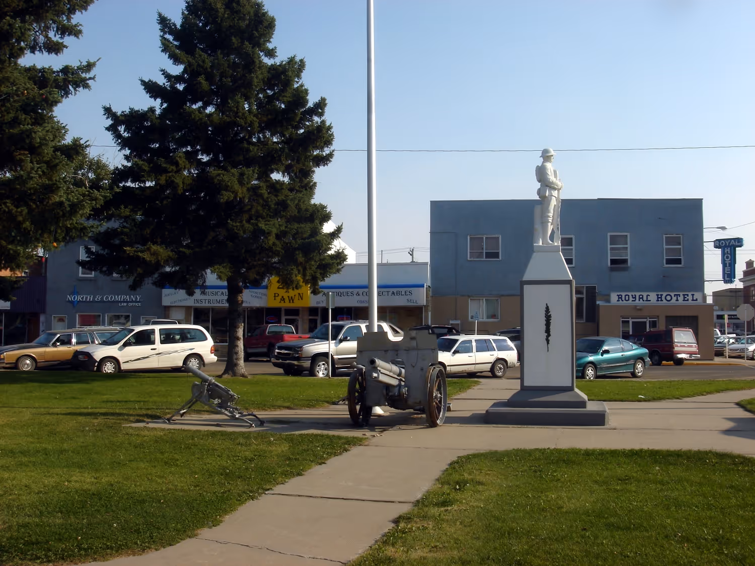 War memorial with soldier statue and cannon in a town park in Taber