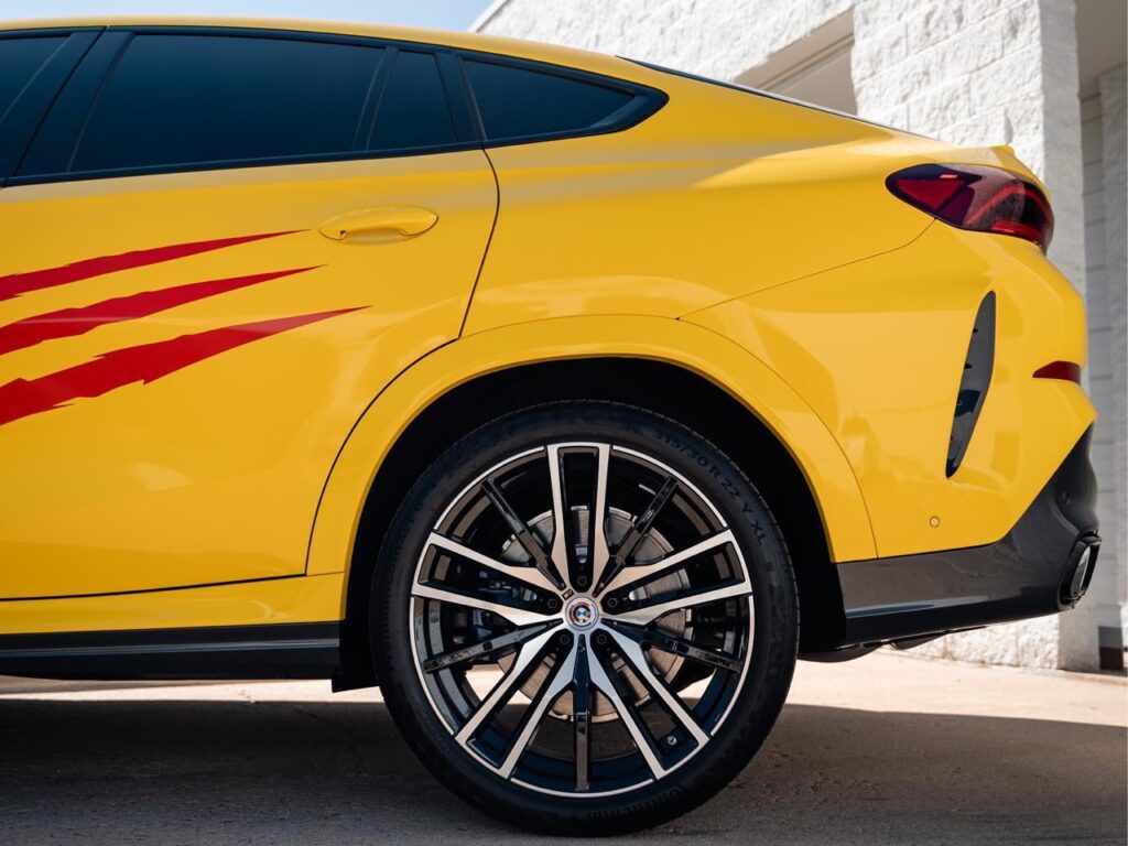 BMW X6 gloss yellow vinyl wrap with red claw decals