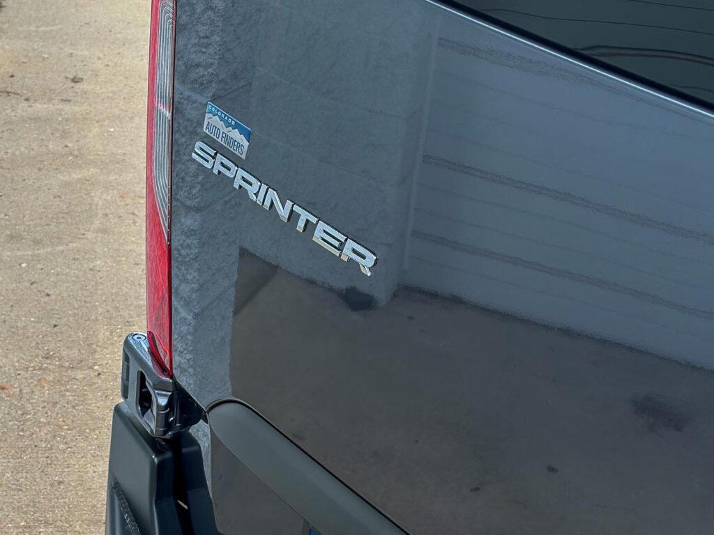 Close-up of Mercedes Sprinter logo at our South Denver custom vehicle shop