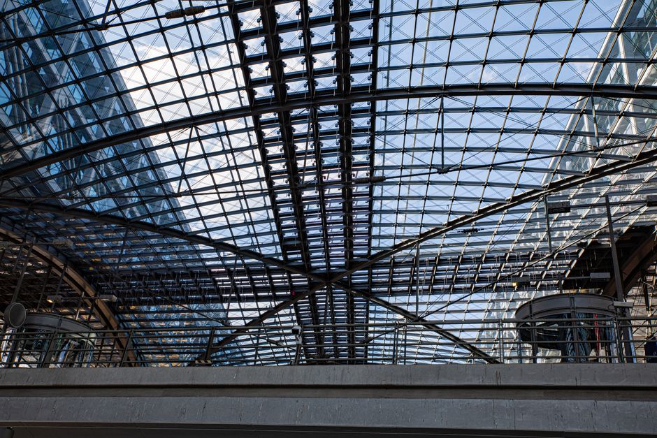 Intricate glass and steel architecture of Berlin Central Station, showcasing modern urban design.