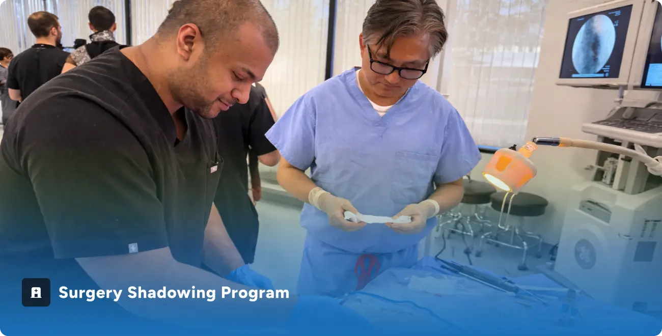 Two medical professionals in scrubs working together in a clinical setting with surgical equipment nearby.