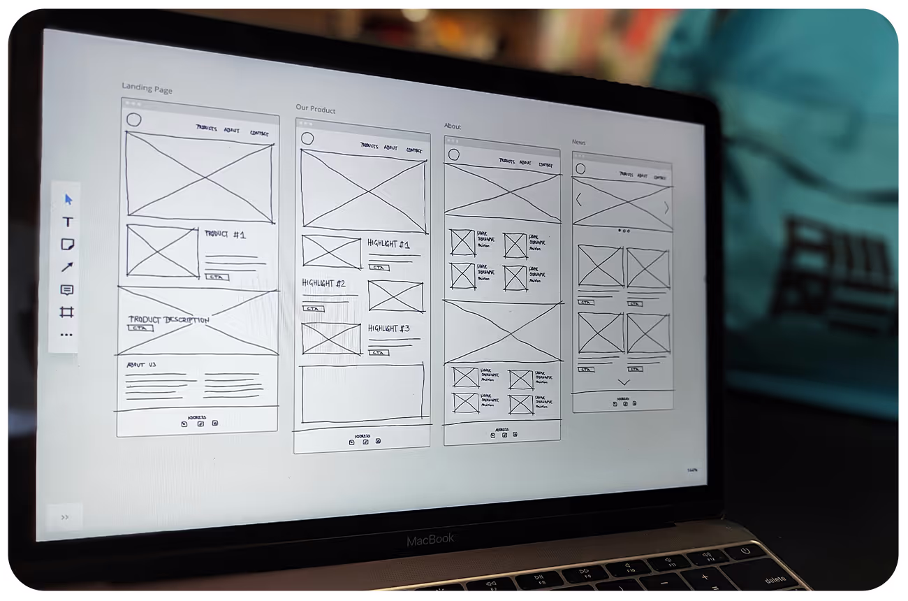 A laptop screen displaying images of wireframes for an app
