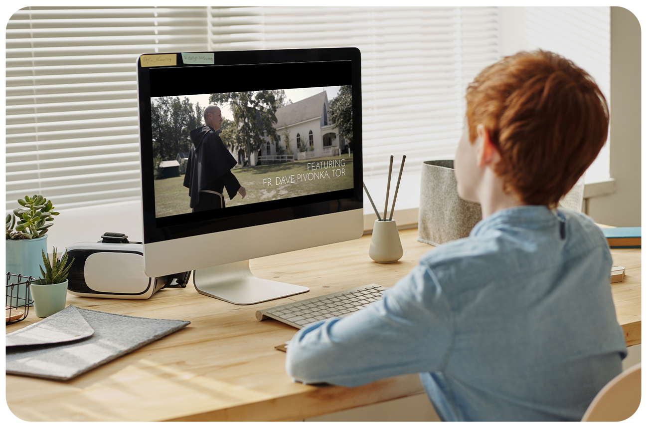 Grade school boy watching a video on a desktop computer from an app built by Annunciate