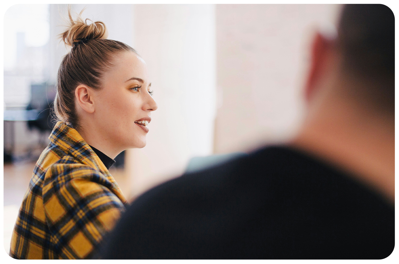 Professional young woman talking at a work meeting