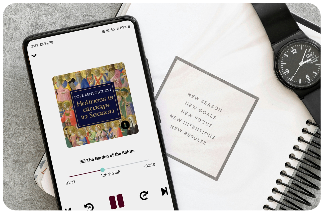 Planner, watch, and smartphone with an audiobook playing on the screen