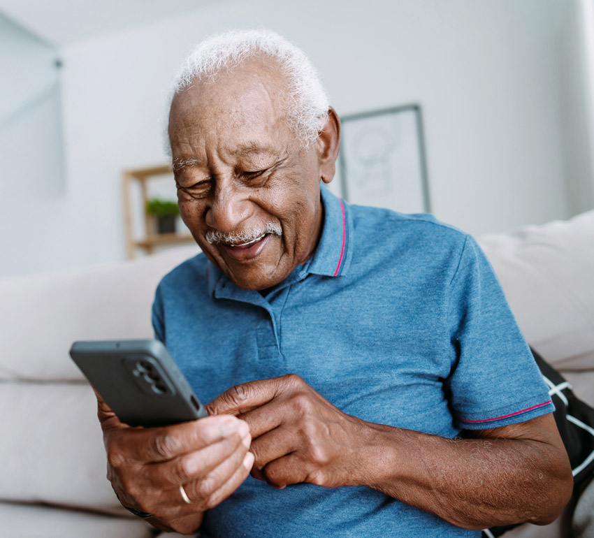 Happy senior looking at mobile screen