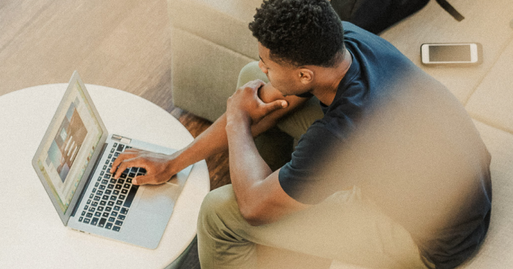 A man deep in thought as he looks at his laptop.