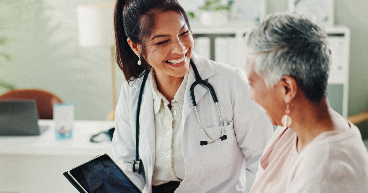 A doctor speaking to her patient with a smile.