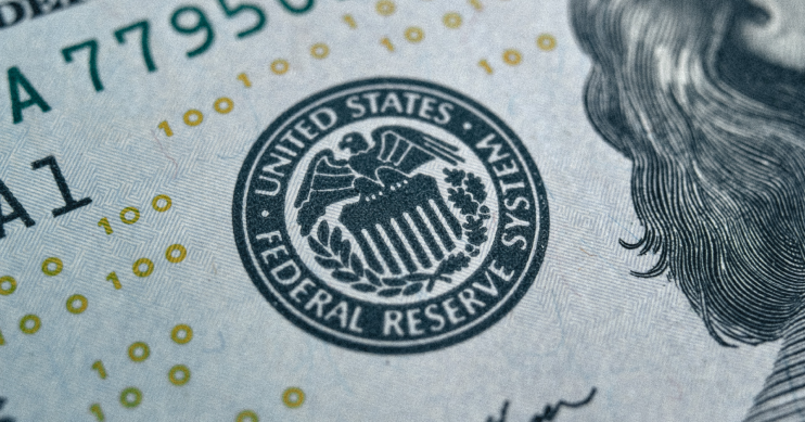 a close up image of the Federal Reserve System emblem on a bill.