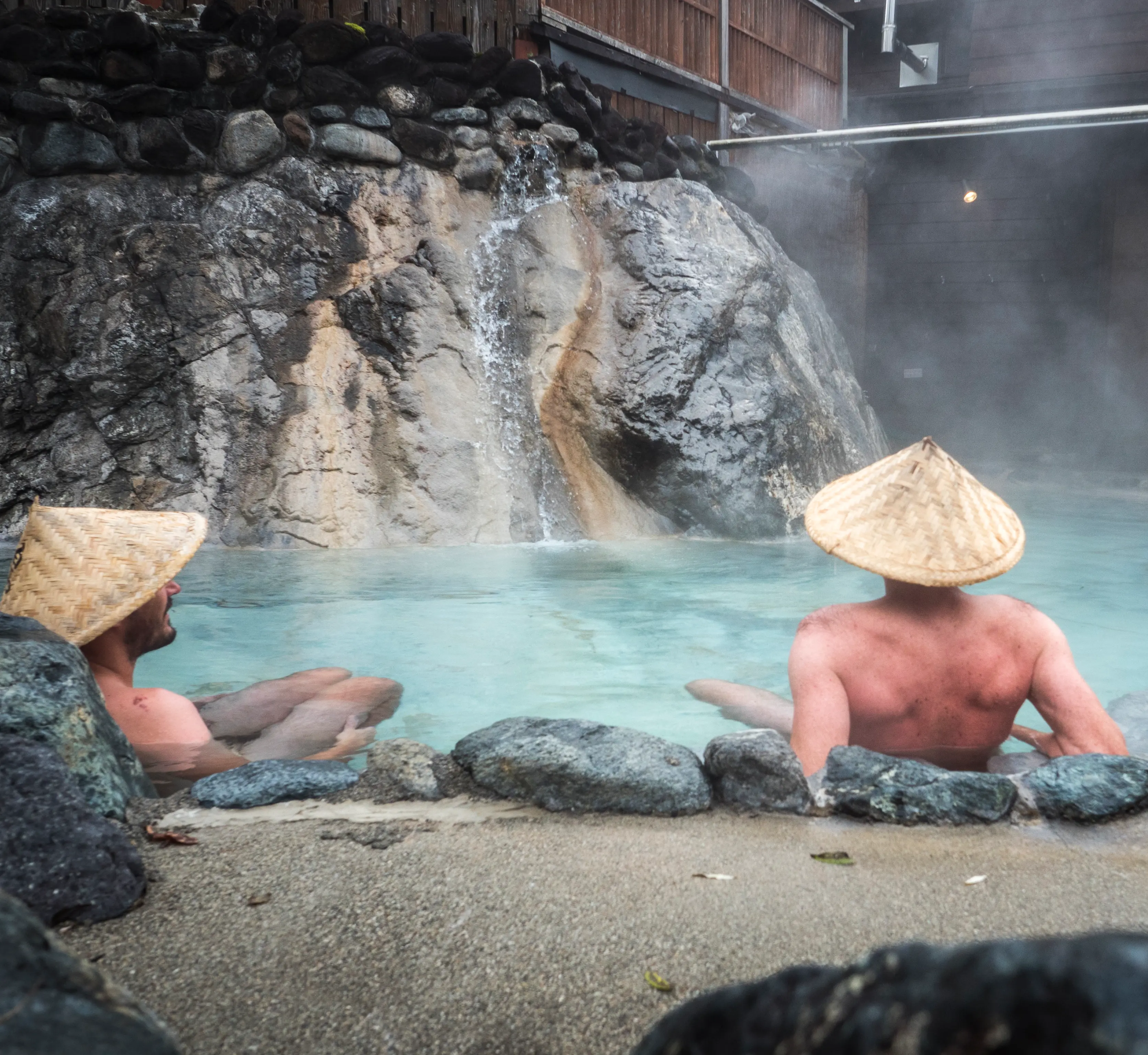 Two men in an outdoor onsen