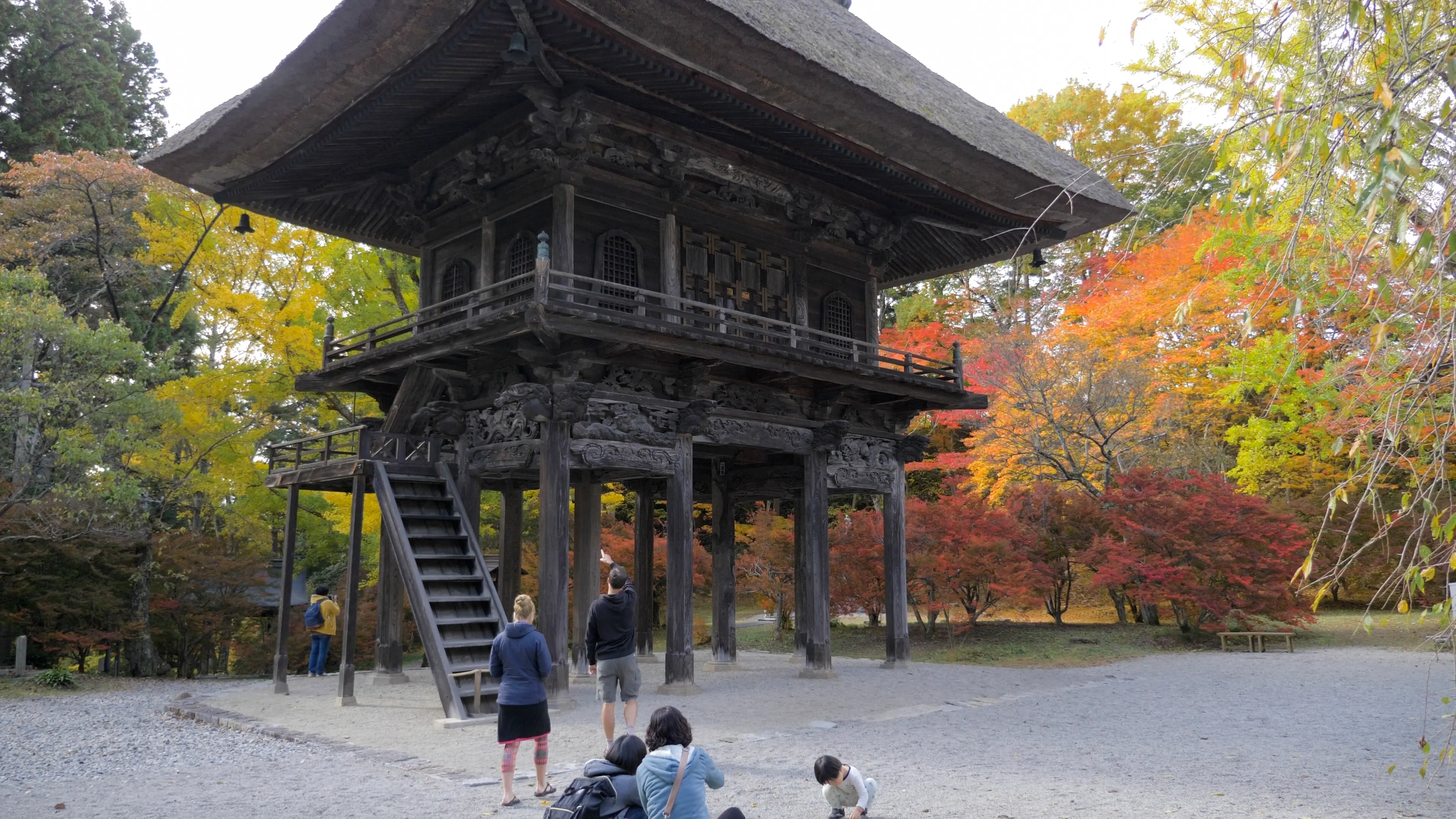 A historic temple surrounded by fall leaves.