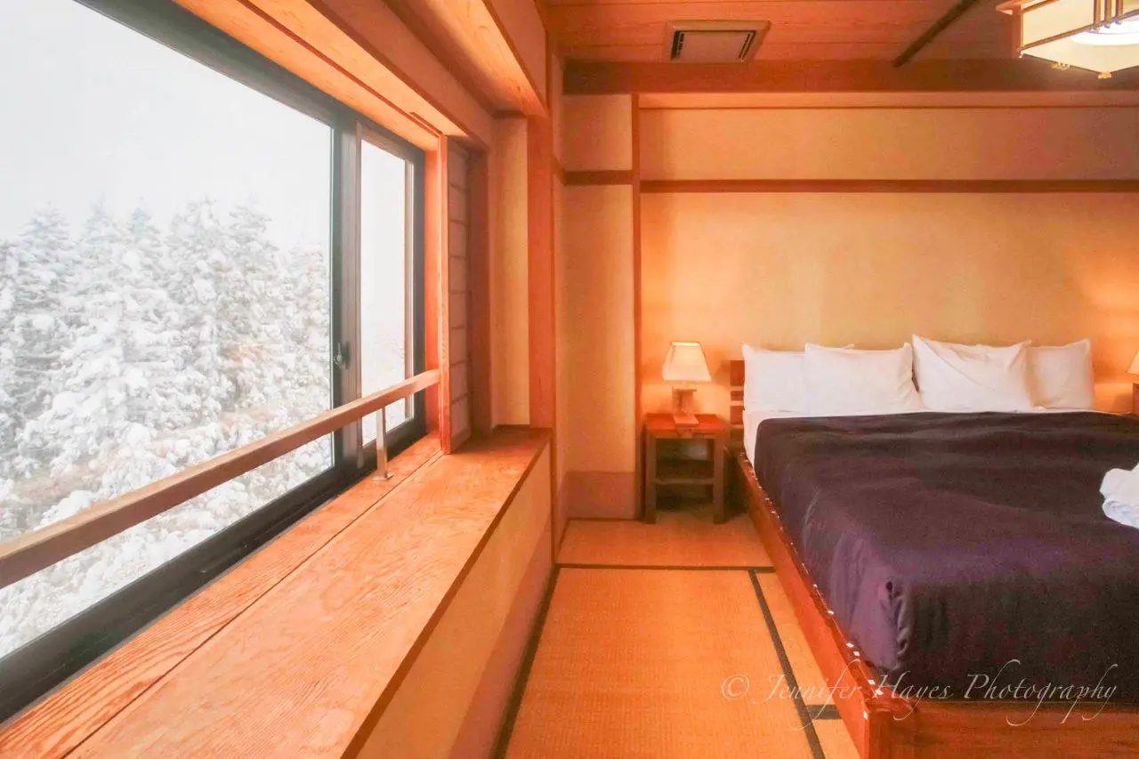 Hotel room with large snowy window scape