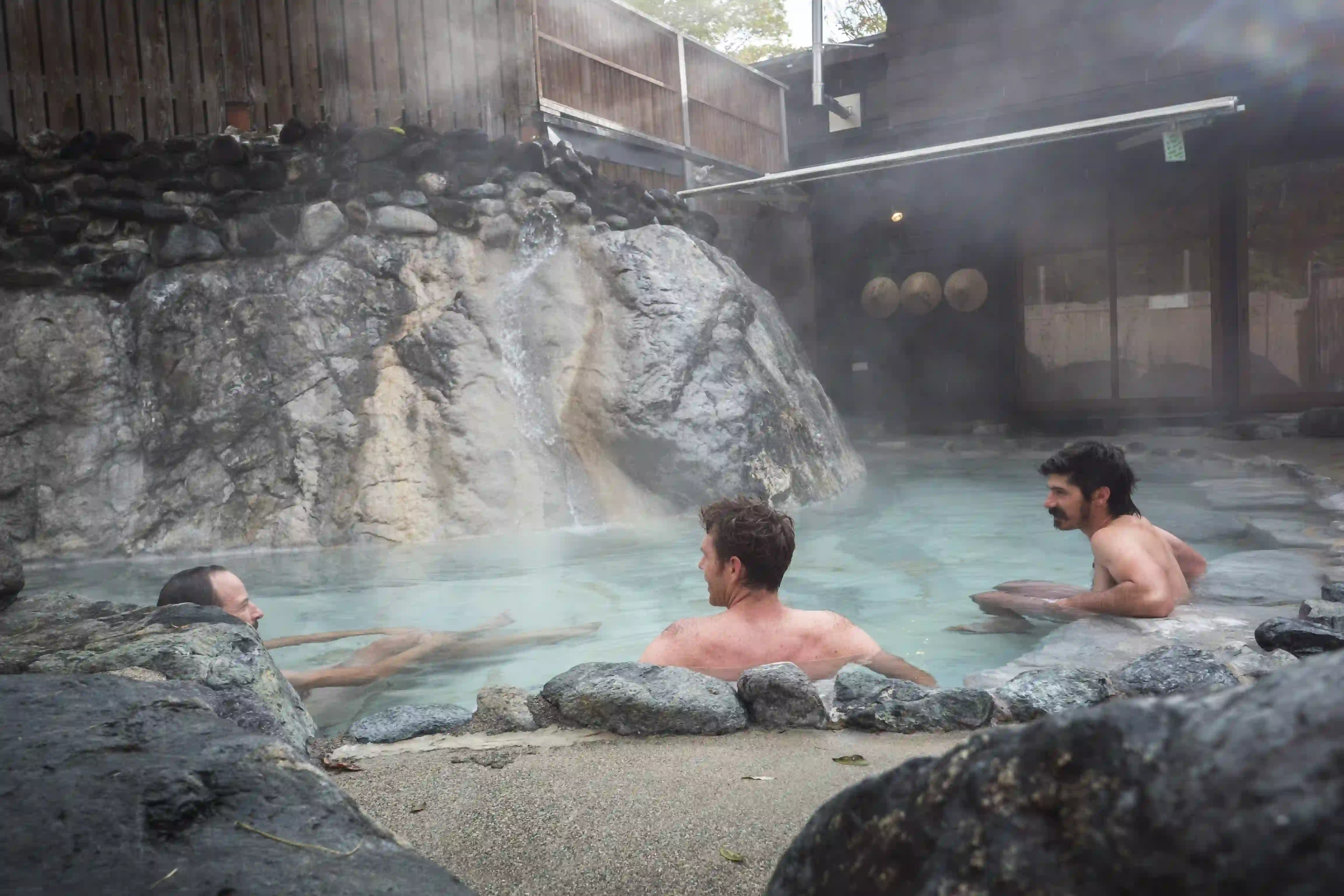 Two men enjoy an after ride onsen.