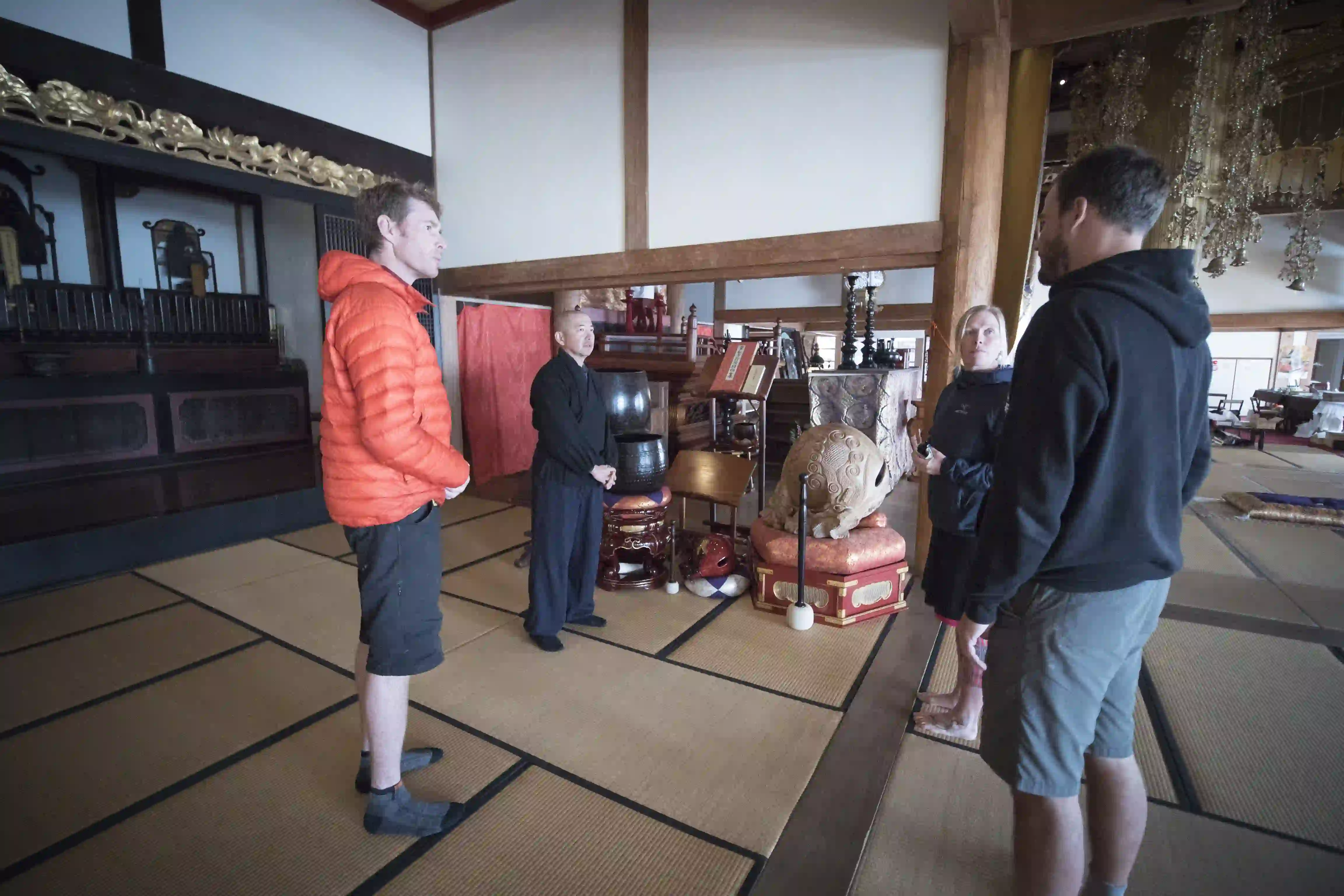 A Japanese/english speaker translates at a temple.