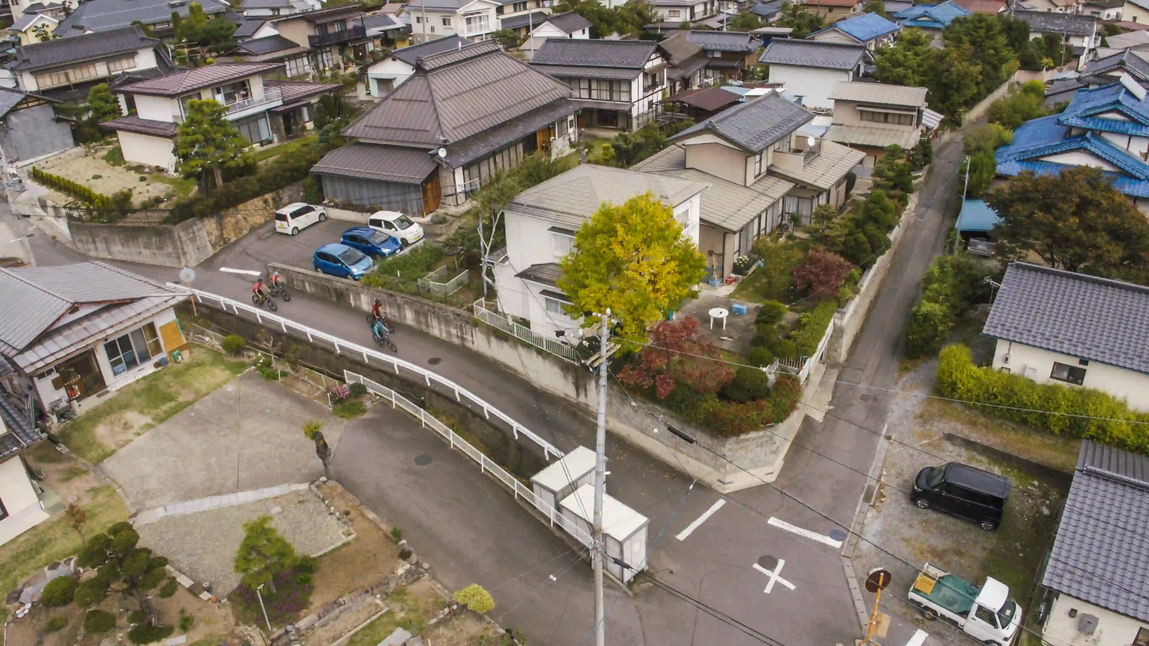 Arial shot of mountain bike riders exciting in a traditional street.
