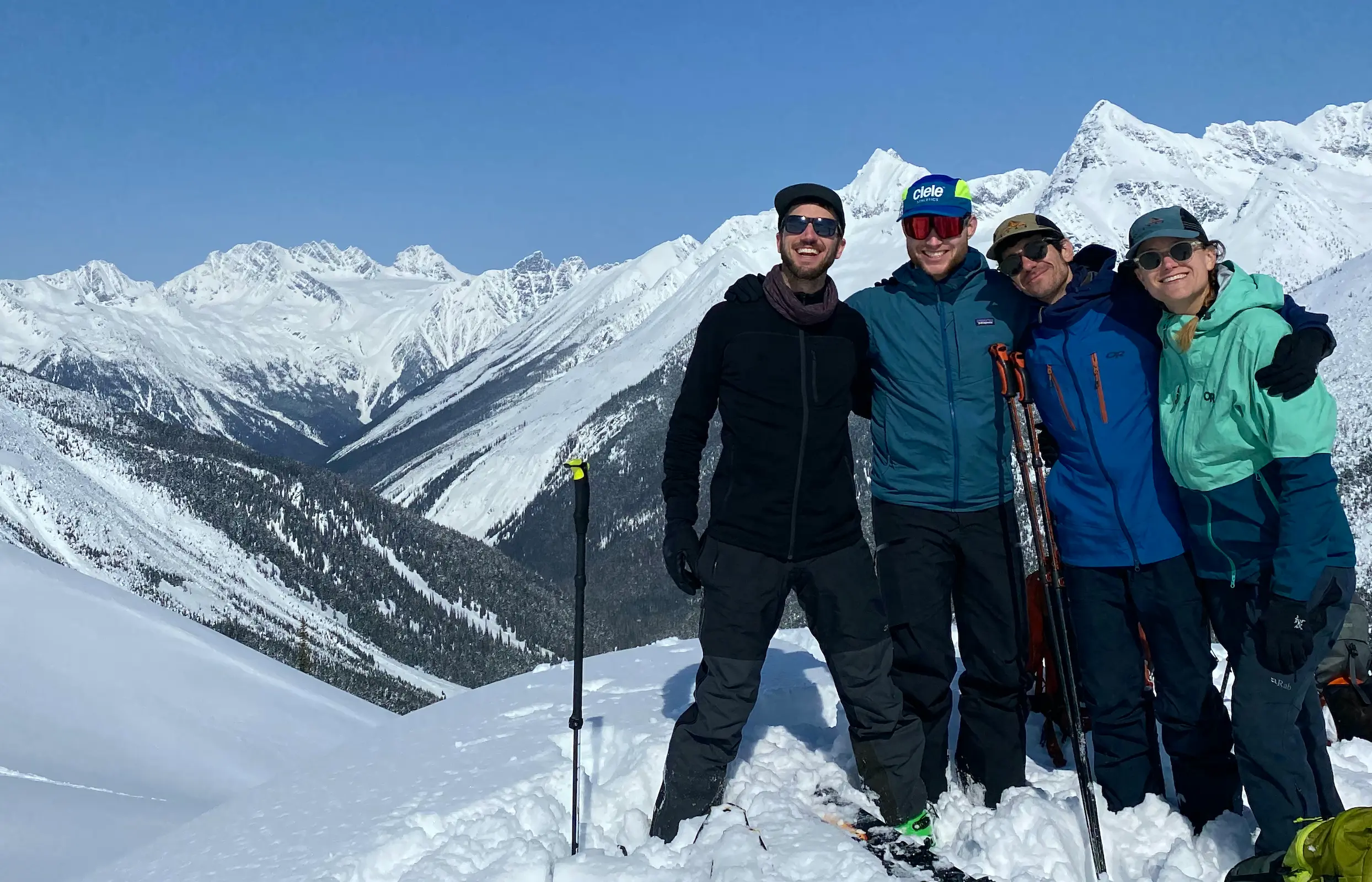 Four friends embracing on a sub summit