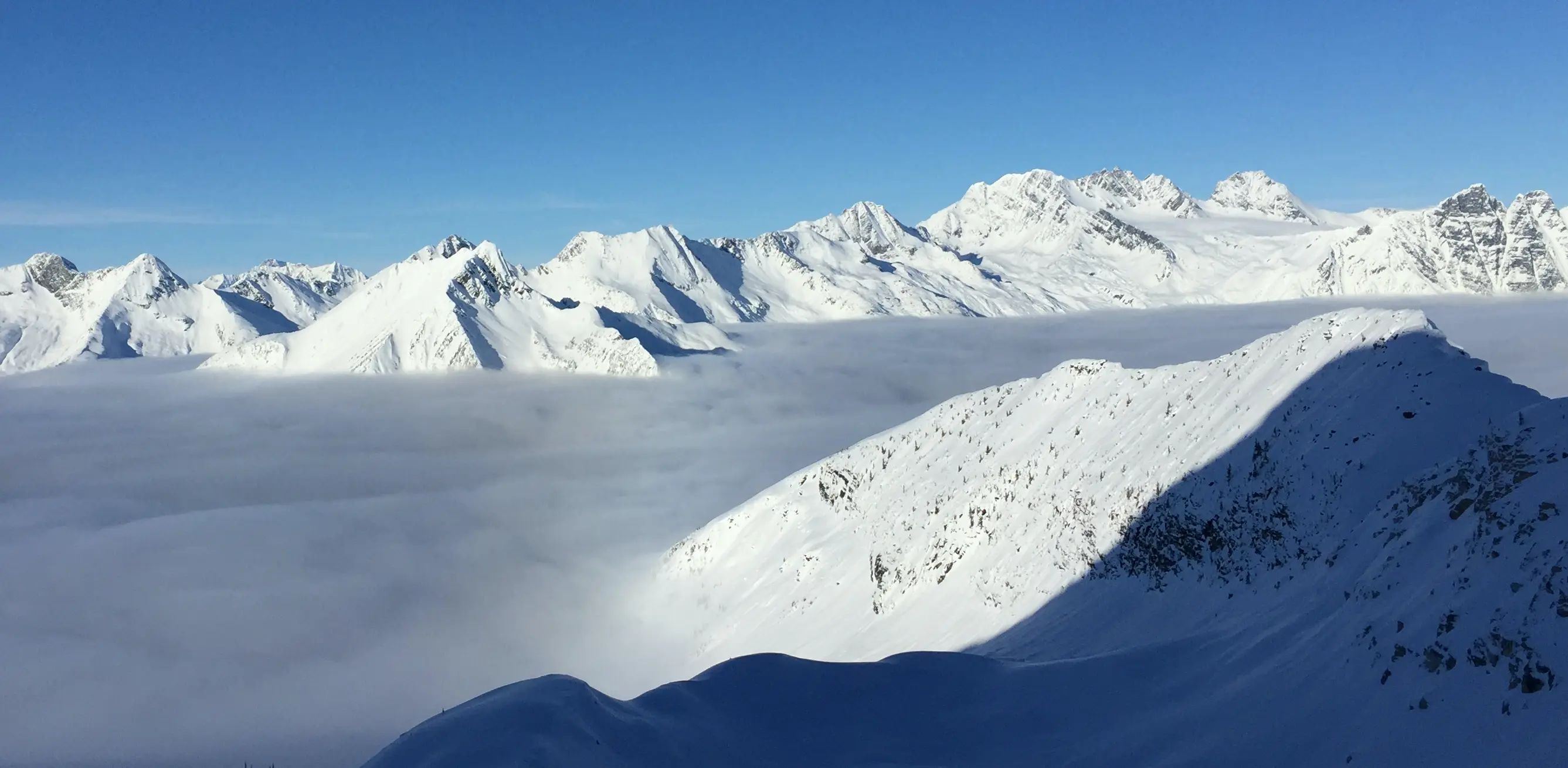 The Selkirk mtns with a sea of clouds in the low valley